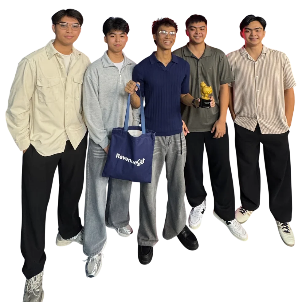 Five members of the Theoraux team standing together, smiling, holding a RevenueCat tote bag and a small gold chicken trophy